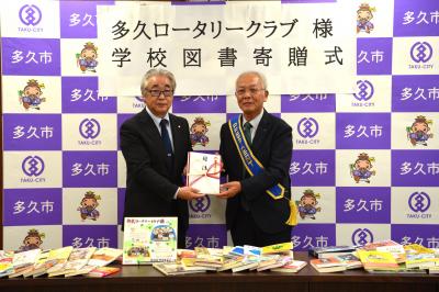 目録贈呈の様子（左から石田教育長、北島会長）